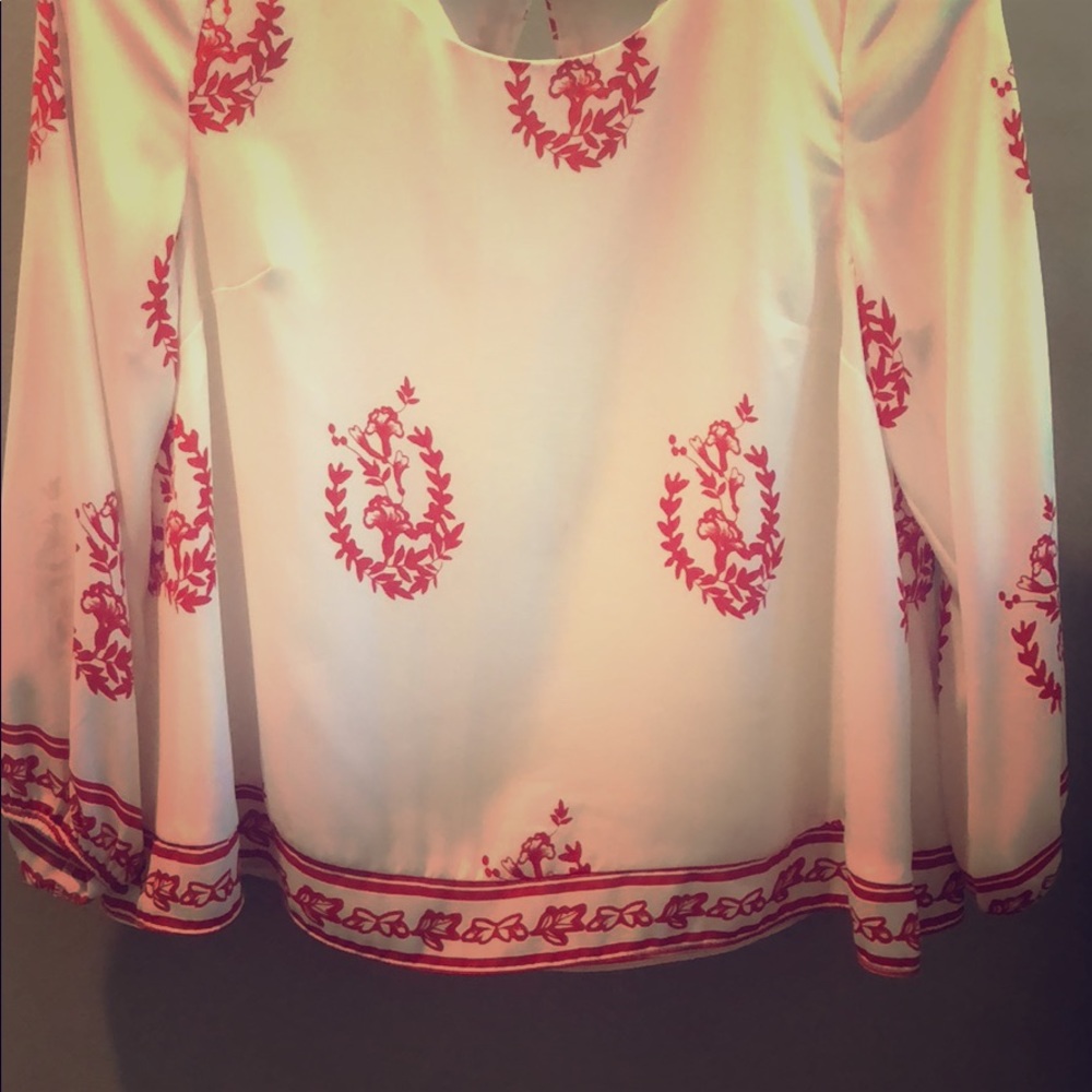 3 quarter length white blouse with red designs